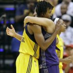 Indiana Fever's Tamika Catchings is hugged by Phoenix Mercury's Diana Taurasi following a first round WNBA playoff basketball game, Wednesday, Sept. 21, 2016, in Indianapolis. Phoenix won the game, 89-78. (AP Photo/Darron Cummings)