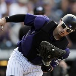 Colorado Rockies catcher Tony Wolters pulls in a pop foul off the bat of Arizona Diamondbacks' Tuffy Gosewisch in the seventh inning of a baseball game Sunday, Sept. 4, 2016, in Denver. (AP Photo/David Zalubowski)