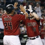 Arizona Diamondbacks' Chris Owings (16) is congratulated by teammate Yasmany Tomas following his two-run home run against the Los Angeles Dodgers to tie a baseball game during the eighth inning of a baseball game, Sunday, Sept. 18, 2016, in Phoenix. (AP Photo/Ralph Freso)