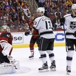 Los Angeles Kings' Teddy Purcell (9) skates away from Arizona Coyotes goalie Mike Smith (41) after Purcell scored a goal as Kings' Kyle Clifford (13) looks for the puck during the first period of a preseason NHL hockey game Monday, Sept. 26, 2016, in Glendale, Ariz. (AP Photo/Ross D. Franklin)