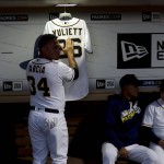 San Diego Padres right fielder Oswaldo Arcia (34) touches a jersey hanging in the dugout in honor of Yuliett Solarte, the wife of San Diego Padres third baseman Yangervis Solarte, before the team plays the Arizona Diamondbacks in a baseball game Monday, Sept. 19, 2016, in San Diego. Yuliette died of complications related to cancer on Saturday. (AP Photo/Gregory Bull)