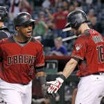 Arizona Diamondbacks' Jean Segura, left, celebrates his home run against the Colorado Rockies with Chris Owings during the first inning of a baseball game Wednesday, Sept. 14, 2016, in Phoenix. (AP Photo/Ross D. Franklin)