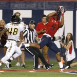 Arizona wide receiver Trey Griffey (5) scores a touchdown in front of Grambling State defensive back Jaterious Pouncey (48) during the second half of an NCAA college football game, Saturday, Sept. 10, 2016, in Tucson, Ariz. Arizona defeated Grambling State 31-21. (AP Photo/Rick Scuteri)