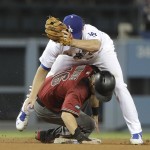 Arizona Diamondbacks' Chris Owings, bottom, is caught stealing second base by Los Angeles Dodgers' Charlie Culberson during the fifth inning of a baseball game, Wednesday, Sept. 7, 2016, in Los Angeles. (AP Photo/Jae C. Hong)