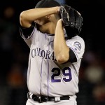 Colorado Rockies pitcher Jorge De La Rosa wipes his face after giving up a run to the Arizona Diamondbacks during the first inning of a baseball game, Tuesday, Sept. 13, 2016, in Phoenix. (AP Photo/Matt York)