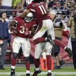 Arizona Cardinals running back David Johnson (31) celebrates his first down run with teammate Larry Fitzgerald during the second half of an NFL football game against the New England Patriots, Sunday, Sept. 11, 2016, in Glendale, Ariz. (AP Photo/Rick Scuteri)