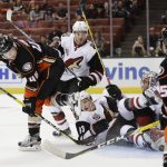 Anaheim Ducks' Max Jones, left, shoots as Arizona Coyotes' Lane Pederson, bottom center and goalie Justin Peters tangle on the ice during the second period of an NHL preseason hockey game, Tuesday, Sept. 27, 2016, in Anaheim, Calif. (AP Photo/Jae C. Hong)