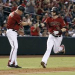 Arizona Diamondbacks' Mitch Haniger (19) is congratulated by third base coach Matt Williams following Haniger's two-run home run against the Los Angeles Dodgers during the fourth inning of a baseball game, Sunday, Sept. 18, 2016, in Phoenix. (AP Photo/Ralph Freso)