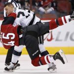Los Angeles Kings' Paul Bissonnette, top, sends Arizona Coyotes' Stefan Fournier (45) to the ice during a fight in the first period of a preseason NHL hockey game Monday, Sept. 26, 2016, in Glendale, Ariz. (AP Photo/Ross D. Franklin)