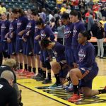 Phoenix Mercury's Kelsey Bone, right, and Mistie Bass, second from right, kneel during the playing of the national anthem before the start of a first round WNBA playoff basketball game against the Indiana Fever, Wednesday, Sept. 21, 2016, in Indianapolis. (AP Photo/Darron Cummings)
