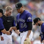 Colorado Rockies manager Walt Weiss, left, takes the ball from relief pitcher Carlos Estevez, third from left, as catcher Tom Murphy, second from left, and shortstop Daniel Descalso and third baseman Nolan Arenado, right, look on in the eighth inning of a baseball game against the Arizona Diamondbacks, Sunday, Sept. 4, 2016, in Denver. (AP Photo/David Zalubowski)
