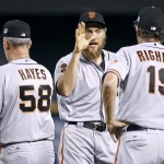 San Francisco Giants' Hunter Pence, center, is congratulated by coaches Bill Hayes (58) and Dave Righetti following a victory over the Arizona Diamondbacks during a baseball game, Sunday, Sept. 11, 2016, in Phoenix. (AP Photo/Ralph Freso)
