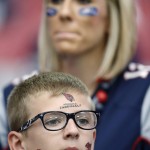 A New England Patriots and Arizona Cardinals fans watch warm ups prior to an NFL football game, Sunday, Sept. 11, 2016, in Glendale, Ariz. (AP Photo/Ross D. Franklin)