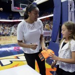 Connecticut Sun's Morgan Tuck, left,  gives an autograph to Kendall Kubachka  as her team warms up before a WNBA basketball game against the Phoenix Mercury, Friday, Sept. 2, 2016, in Uncasville, Conn. Tuck, a forward rookie, will miss the rest of the WNBA season because of a left knee injury. The Sun said Thursday that Tuck will have surgery to repair torn cartilage. (AP Photo/Jessica Hill)