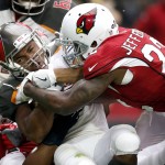 Tampa Bay Buccaneers running back Doug Martin his hit by Arizona Cardinals strong safety Tony Jefferson (22) during the first half of an NFL football game, Sunday, Sept. 18, 2016, in Glendale, Ariz. (AP Photo/Ross D. Franklin)