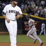 Arizona Diamondbacks' Edwin Escobar, left, pauses on the mound after giving up a home run to San Francisco Giants' Angel Pagan, right, during the seventh inning of a baseball game Friday, Sept. 9, 2016, in Phoenix. (AP Photo/Ross D. Franklin)