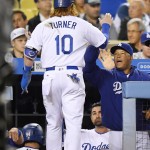 Los Angeles Dodgers' Justin Turner is congratulated by manager Dave Roberts after scoring on single by Josh Reddick during the third inning of a baseball game against the Arizona Diamondbacks, Tuesday, Sept. 6, 2016, in Los Angeles. (AP Photo/Mark J. Terrill)