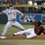 Los Angeles Dodgers shortstop Corey Seager (5) stretches to touch second base before Arizona Diamondbacks' Mitch Haniger on a force play after a throwing error by Dodgers' Charlie Culberson during the second inning of a baseball game, Sunday, Sept. 18, 2016, in Phoenix. Haniger was safe on the play. (AP Photo/Ralph Freso)