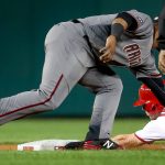 Arizona Diamondbacks second baseman Jean Segura (2) tags out Washington Nationals' Trea Turner (7) as he attempts to steal second base in the first inning of a baseball game at Nationals Park in Washington, Monday, Sept. 26, 2016. (AP Photo/Andrew Harnik)