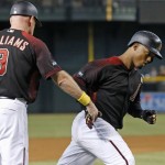 Arizona Diamondbacks' Jean Segura, right, slaps hands with third base coach Matt Williams (9) as Segura rounds the bases after hitting a home run against the Los Angeles Dodgers during the first inning of a baseball game Saturday, Sept. 17, 2016, in Phoenix. (AP Photo/Ross D. Franklin)