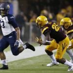 Northern Arizona's Kendyl Taylor (13) runs for a first down as he is forced out of bounds by Arizona State's Kareem Orr (25) and Marcus Ball, right, during the first half of an NCAA college football game Saturday, Sept. 3, 2016, in Tempe, Ariz. (AP Photo/Ross D. Franklin)