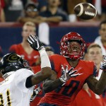 Arizona wide receiver Samajie Grant (10) makes the catch over Grambling State defender Joseph McWilliams (31) during the first half of an NCAA college football game, Saturday, Sept. 10, 2016, in Tucson, Ariz. (AP Photo/Rick Scuteri)