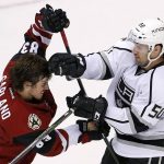 Los Angeles Kings' Vincent LoVerde (50) mixes it up with Arizona Coyotes' Conor Garland, left, as both get roughing penalties during the third period of a preseason NHL hockey game Monday, Sept. 26, 2016, in Glendale, Ariz. The Coyotes defeated the Kings 5-3. (AP Photo/Ross D. Franklin)