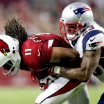 Arizona Cardinals wide receiver Larry Fitzgerald (11) is hit by New England Patriots strong safety Patrick Chung (23) during the first half of an NFL football game, Sunday, Sept. 11, 2016, in Glendale, Ariz. (AP Photo/Ross D. Franklin)