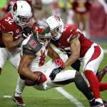 Tampa Bay Buccaneers wide receiver Vincent Jackson (83) is hit by Arizona Cardinals defensive back Tyvon Branch (27) and safety Tyrann Mathieu (32) during the second half of an NFL football game, Sunday, Sept. 18, 2016, in Glendale, Ariz. (AP Photo/Ross D. Franklin)
