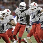 Arizona safety Demetrius Flannigan-Fowles (6) celebrates with Michael Barton (11) and Tristan Cooper (31) after intercepting a pass during the first half of an NCAA college football game against Hawaii, Saturday, Sept. 17, 2016, in Tucson, Ariz. (AP Photo/Rick Scuteri)