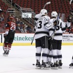 Los Angeles Kings' Matt Luff (64) celebrates his goal with teammates Justin Gutierrez (43) and Jacob Moverare, right, as Arizona Coyotes' Brendan Perlini (29) and MacKenzie Braid (86) skate away during the first period of an NHL rookies hockey game Tuesday, Sept. 20, 2016, in Glendale, Ariz. (AP Photo/Ross D. Franklin)