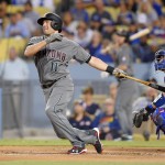 Arizona Diamondbacks' A.J. Pollock, left, hits a solo home run as Los Angeles Dodgers catcher Yasmani Grandal watches during the first inning of a baseball game, Tuesday, Sept. 6, 2016, in Los Angeles. (AP Photo/Mark J. Terrill)