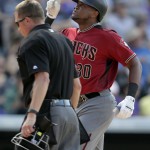 Arizona Diamondbacks' Socrates Brito, right, gestures as he crosses home plate after hitting a 
three-run home run off Colorado Rockies starting pitcher Jon Gray as home plate umpire Cory Blaser, left, looks on in the seventh inning of a baseball game Sunday, Sept. 4, 2016, in Denver. (AP Photo/David Zalubowski)