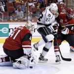 Arizona Coyotes' Mike Smith (41) makes a save on a shot by Los Angeles Kings' Trevor Lewis (22) as Coyotes' Jalen Smereck (59) and Dysin Mayo (61) defend during the first period of a preseason NHL hockey game Monday, Sept. 26, 2016, in Glendale, Ariz. (AP Photo/Ross D. Franklin)