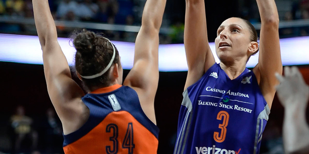 Phoenix Mercury's Diana Taurasi shoots as Connecticut Sun's Kelly Faris, left, defends during the s...
