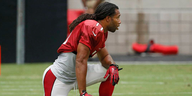 Arizona Cardinals' Larry Fitzgerald takes a break after drills during practice at the NFL football ...