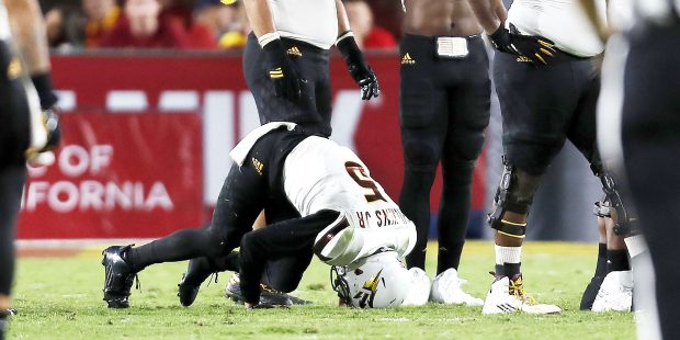 Arizona State quarterback Manny Wilkins (5) stays on the ground after being sacked during the first...