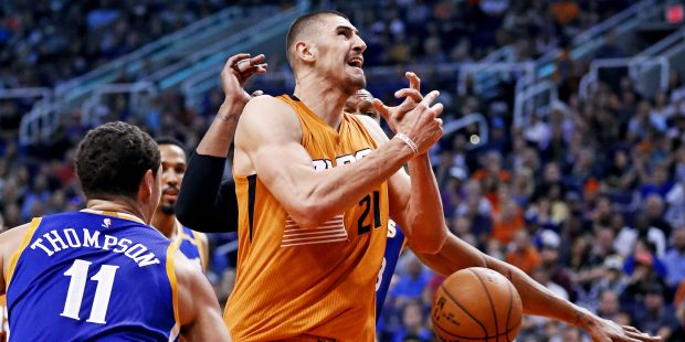 Phoenix Suns center Alex Len (21) gets the ball stripped by Golden State Warriors guard Klay Thomps...