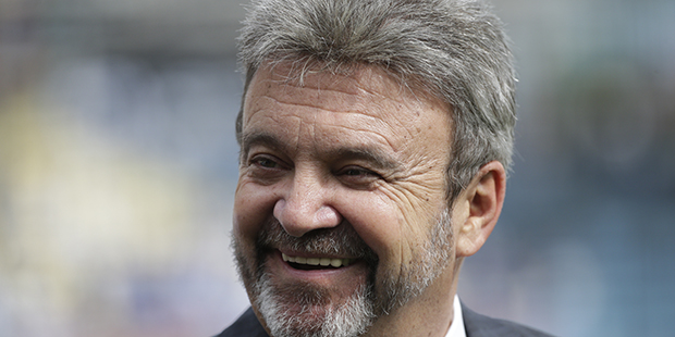 Los Angeles Dodgers general manager Ned Colletti smiles before a baseball game between the Los Ange...