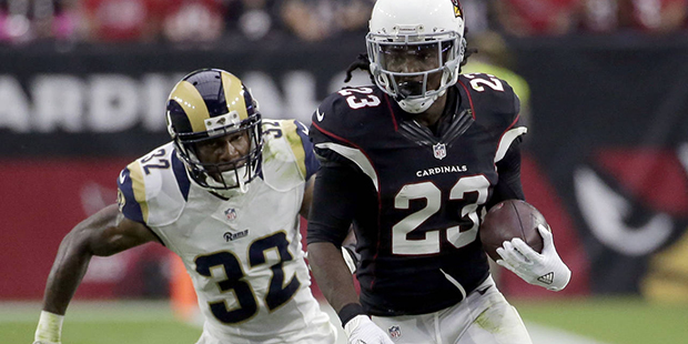 Arizona Cardinals running back Chris Johnson (23) is chased by Los Angeles Rams cornerback Troy Hil...