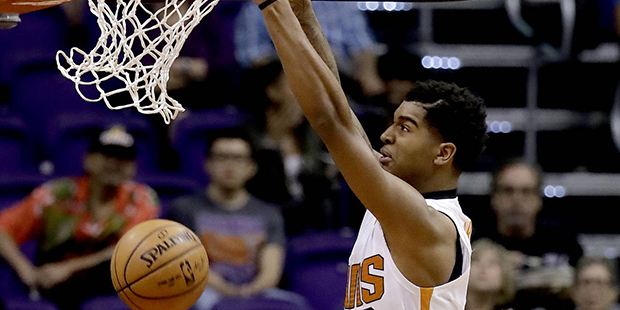 Phoenix Suns forward Marquese Chriss (0) dunks over Dallas Mavericks center Andrew Bogut as Suns' E...