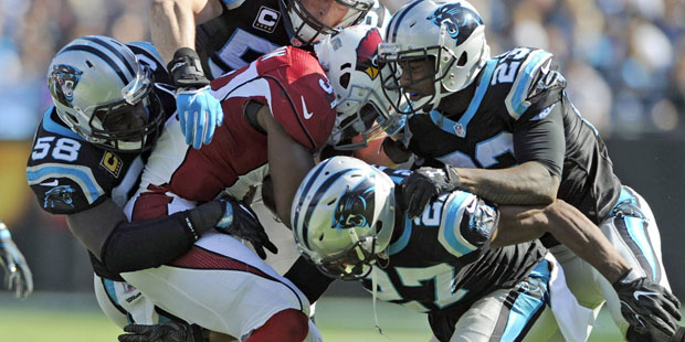 Arizona Cardinals' David Johnson, center, is tackled by Carolina Panthers players in the second hal...