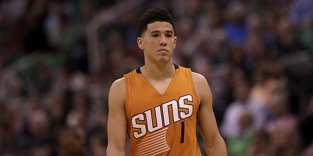 Phoenix Suns' Devin Booker (1)  on the court during the first half of an NBA basketball game agains...