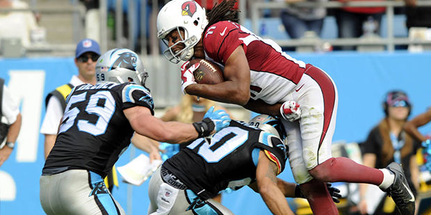 Arizona Cardinals' Larry Fitzgerald (11) is upended by Carolina Panthers' Kurt Coleman (20) in the ...