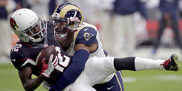 Arizona Cardinals wide receiver John Brown (12) is hit by Los Angeles Rams strong safety T.J. McDon...