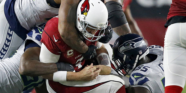 Arizona Cardinals quarterback Carson Palmer (3) is sacked by Seattle Seahawks defensive end Frank C...