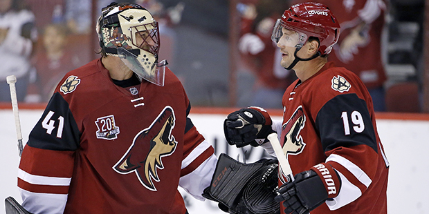 Arizona Coyotes' Mike Smith (41) and Shane Doan (19) celebrate the Coyotes' 3-1 win over the San Jo...