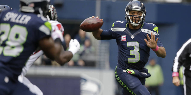 Seattle Seahawks quarterback Russell Wilson (3) prepares to make a 24-yard pass to running back C.J...