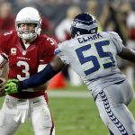 Arizona Cardinals quarterback Carson Palmer (3) scrambles as Seattle Seahawks defensive end Frank Clark (55) pursues during the first half of a football game, Sunday, Oct. 23, 2016, in Glendale, Ariz. (AP Photo/Ross D. Franklin)