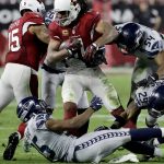 Arizona Cardinals wide receiver Larry Fitzgerald (11) is hit by Seattle Seahawks middle linebacker Bobby Wagner (54), free safety Earl Thomas (29) and cornerback DeShawn Shead (35) during the second half of a football game, Sunday, Oct. 23, 2016, in Glendale, Ariz. (AP Photo/Rick Scuteri)
